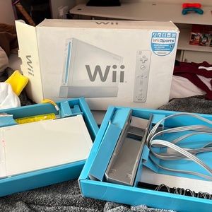 Wii console with cords, 1 remote and joystick, motion bar, and 23 games